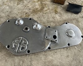 The cam cover is lightly polished and prepared for the "engine turn" process.